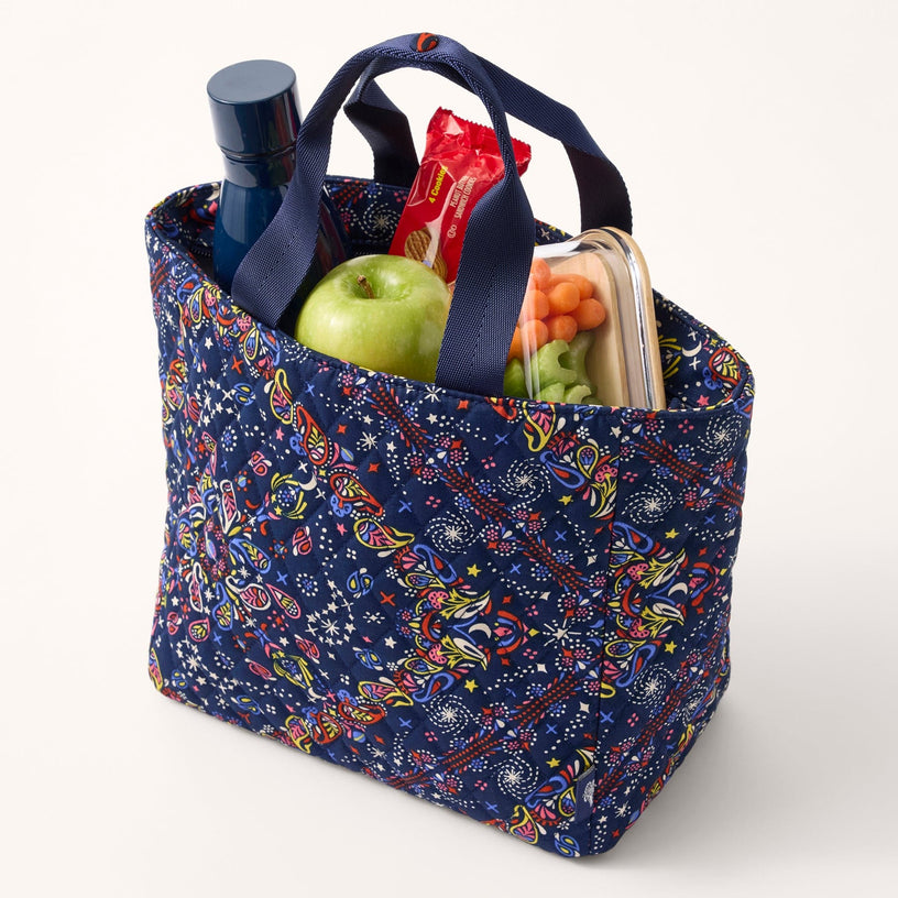 dark blue insulated lunch tote bag with multicolor pattern shown with water bottle and lunch items inside