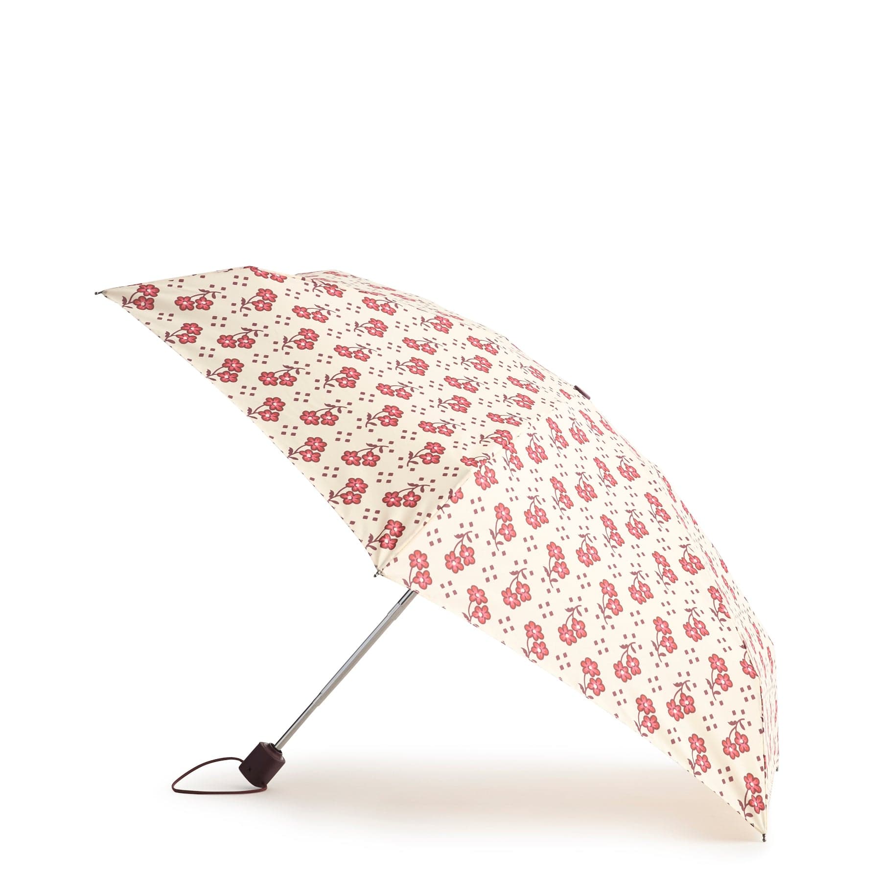 cream colored umbrella with small red flowers shown open and tilted against floors