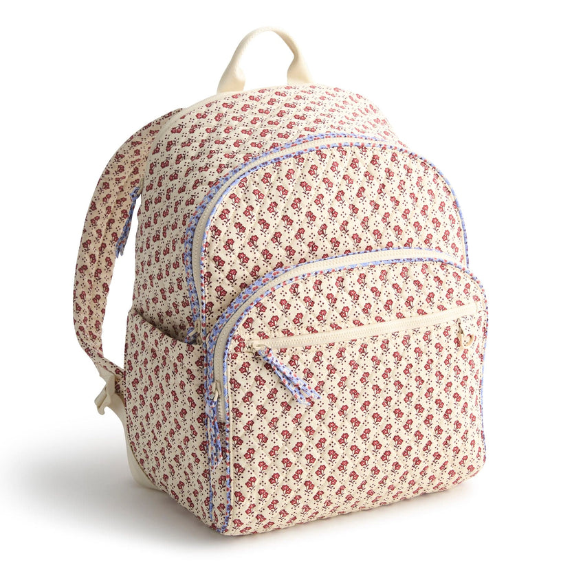 cream backpack with small red flowers pattern and blue trim